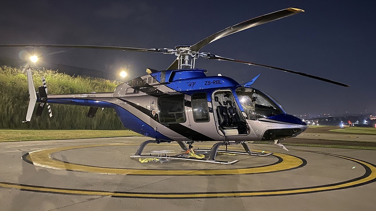 Bell 407 ZS-RLO doing an LED banner lift from Ultimate Heliport, Midrand