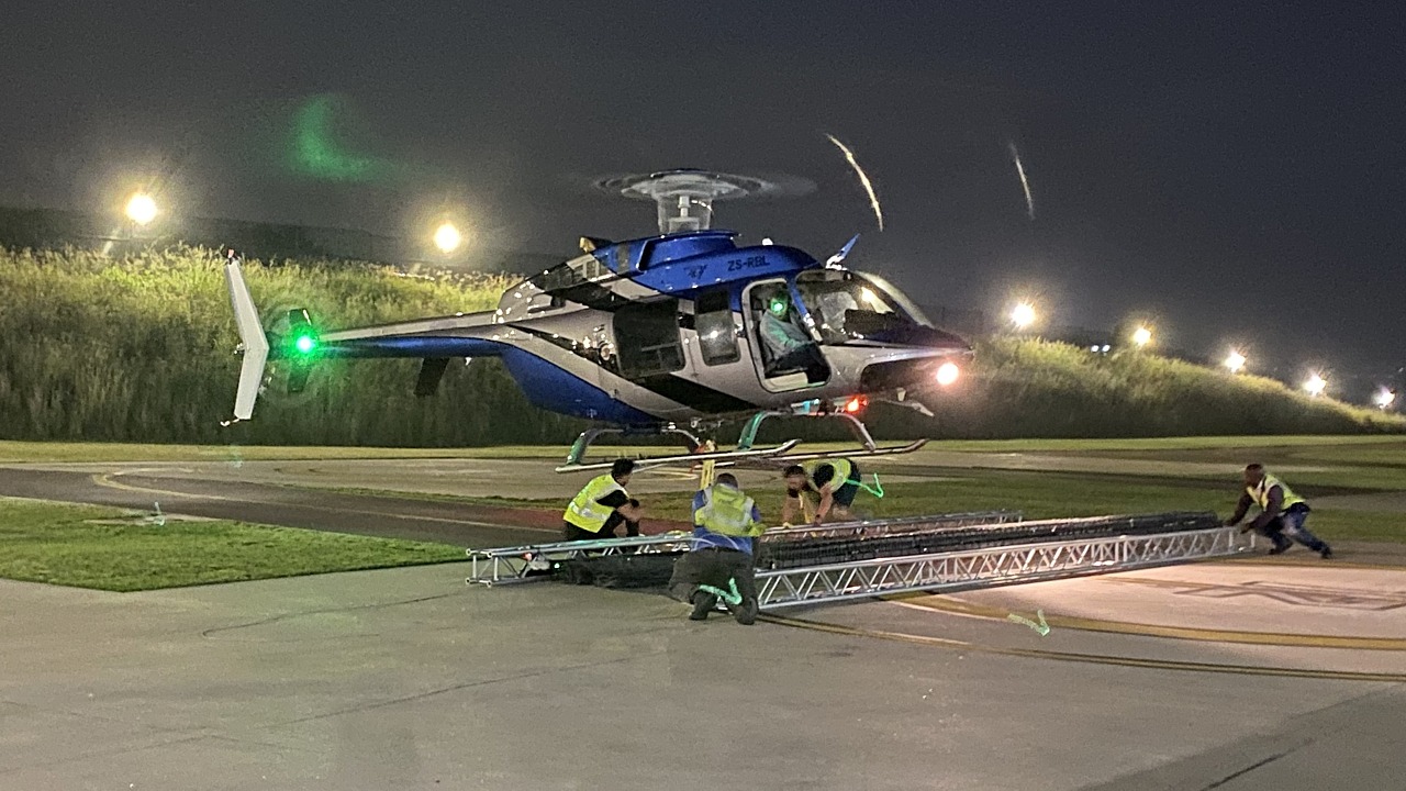 Bell 407 ZS-RLO doing an LED banner lift from Ultimate Heliport, Midrand
