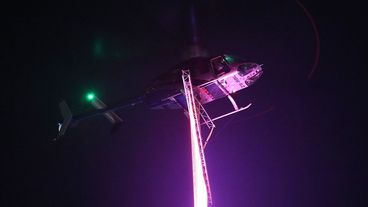 Bell 407 ZS-RLO doing an LED banner lift from Ultimate Heliport, Midrand